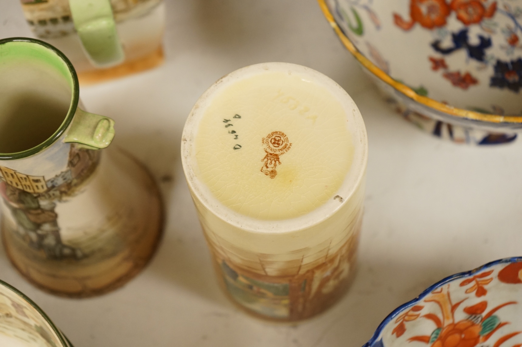 A collection of French, Japanese and English ceramics to include Royal Doulton Dickensware, Imari bowls and a faience glazed cat